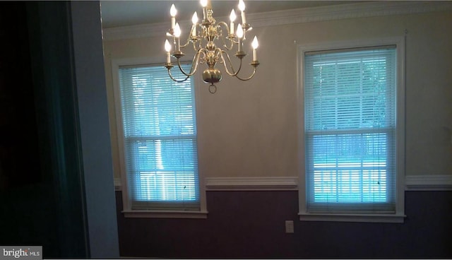 details featuring an inviting chandelier and ornamental molding