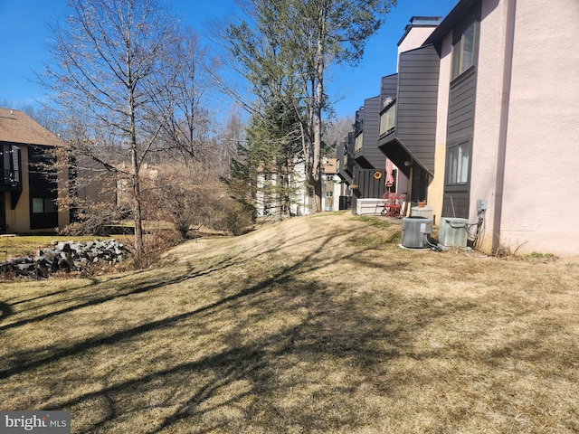 view of yard featuring a residential view and central AC