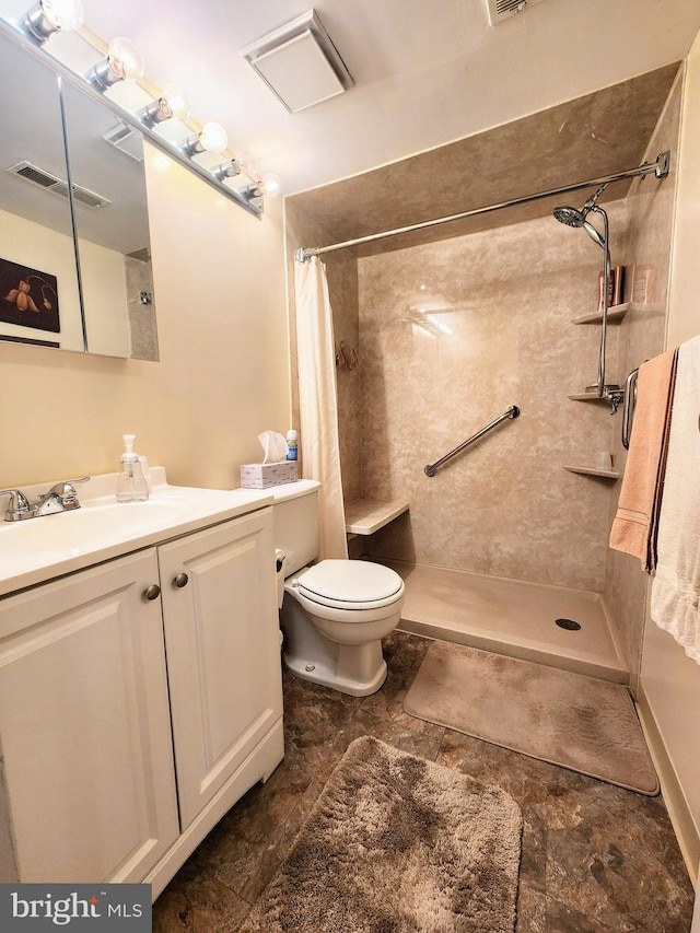 full bathroom featuring visible vents, toilet, stone finish flooring, a tile shower, and vanity