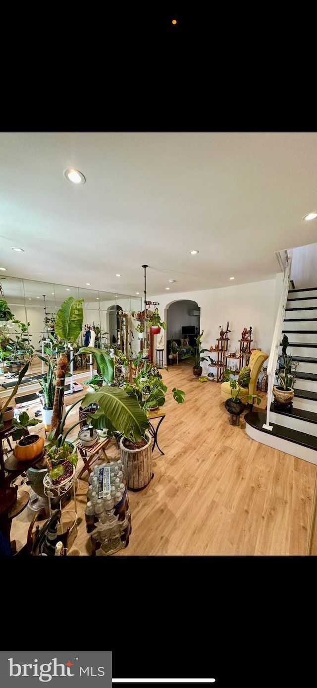 living area featuring stairway, recessed lighting, and wood finished floors