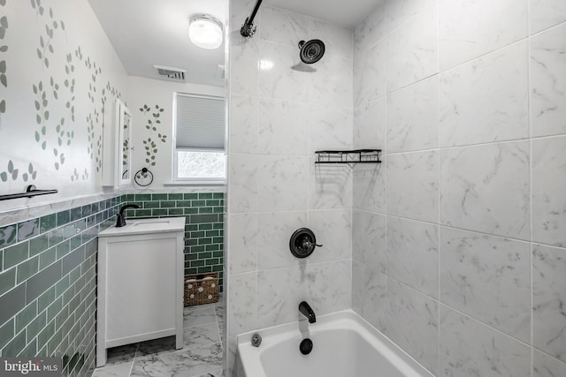 bathroom with visible vents, tile walls, shower / bathtub combination, marble finish floor, and vanity