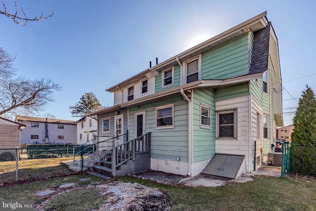 view of front of property featuring central AC and fence