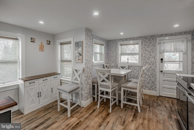 dining area with recessed lighting, wallpapered walls, light wood-type flooring, and baseboards