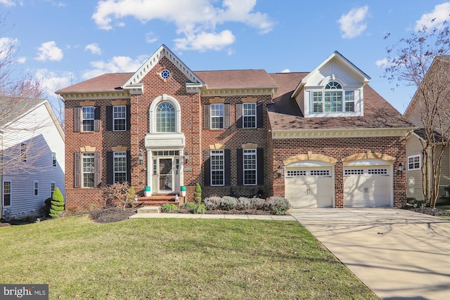 colonial-style house featuring a front yard, an attached garage, brick siding, and driveway