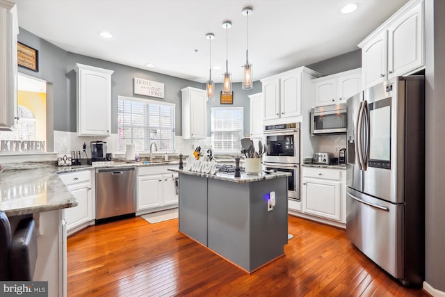 kitchen featuring a sink, stainless steel appliances, and white cabinets