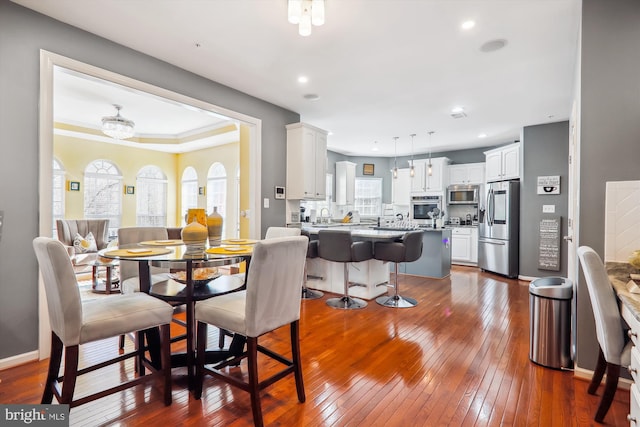 dining area with recessed lighting, baseboards, and dark wood-style floors