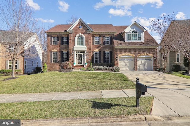 view of front of property featuring a front yard, brick siding, and driveway