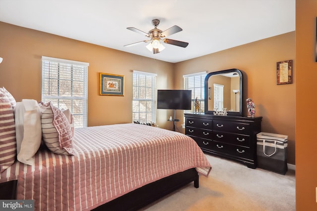 bedroom with light carpet and ceiling fan