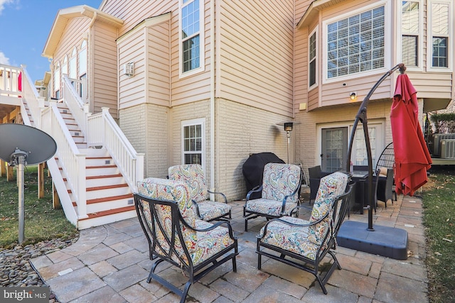 view of patio featuring an outdoor living space and stairway