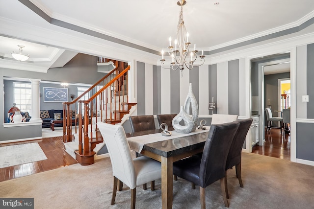 dining space featuring stairs, ornate columns, carpet floors, and ornamental molding