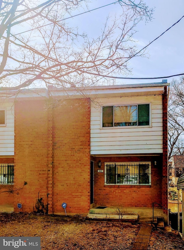 view of property exterior featuring brick siding