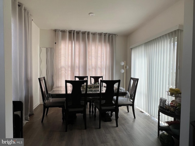 dining space with wood finished floors