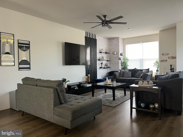 living room featuring ceiling fan and dark wood-style floors