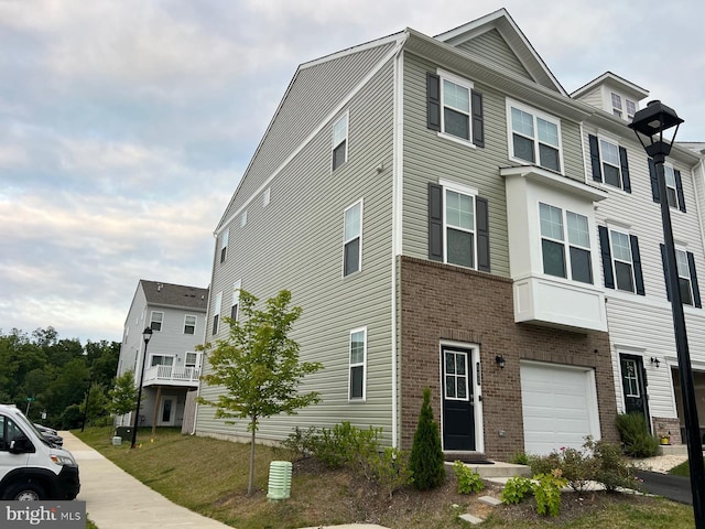 multi unit property with brick siding and an attached garage