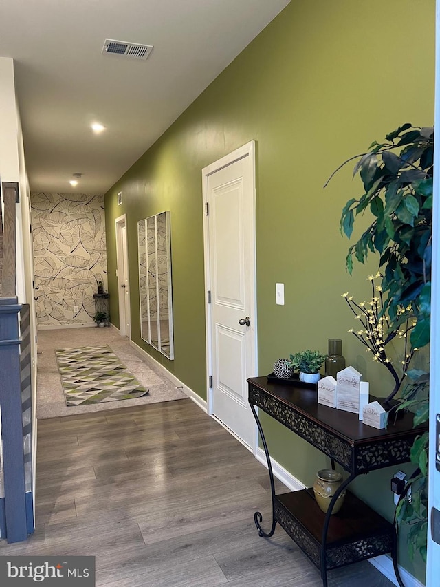 foyer entrance featuring wood finished floors and visible vents