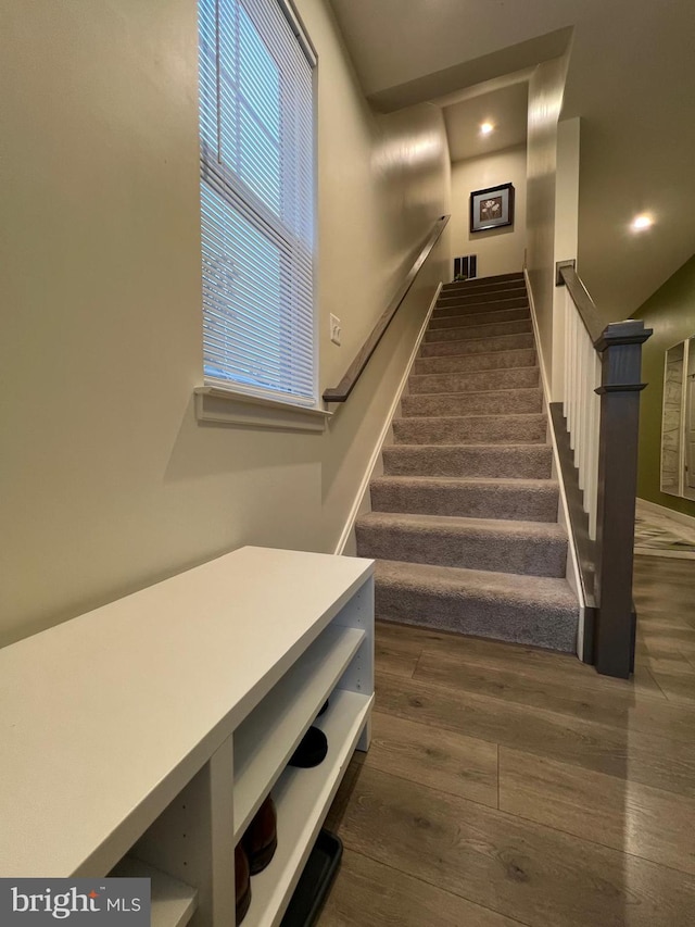 stairway featuring hardwood / wood-style flooring