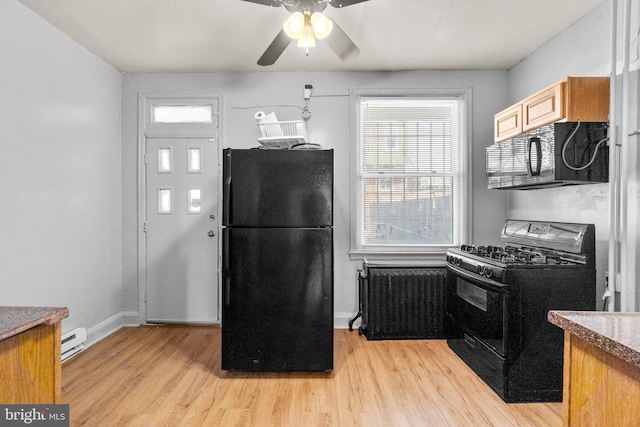 kitchen featuring a baseboard heating unit, ceiling fan, radiator heating unit, light wood-style flooring, and black appliances