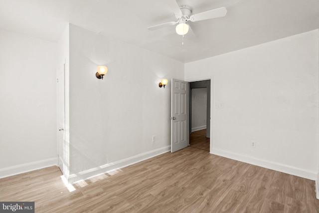 interior space with light wood-style flooring, baseboards, and ceiling fan