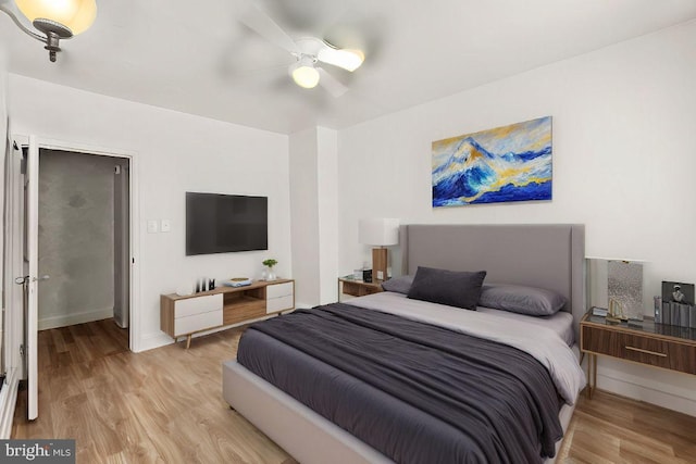 bedroom with light wood-type flooring and ceiling fan