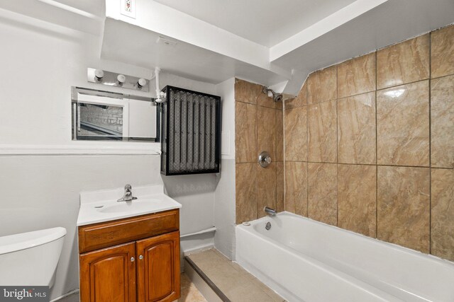 bathroom featuring tile patterned flooring, toilet, vanity, and shower / bathtub combination