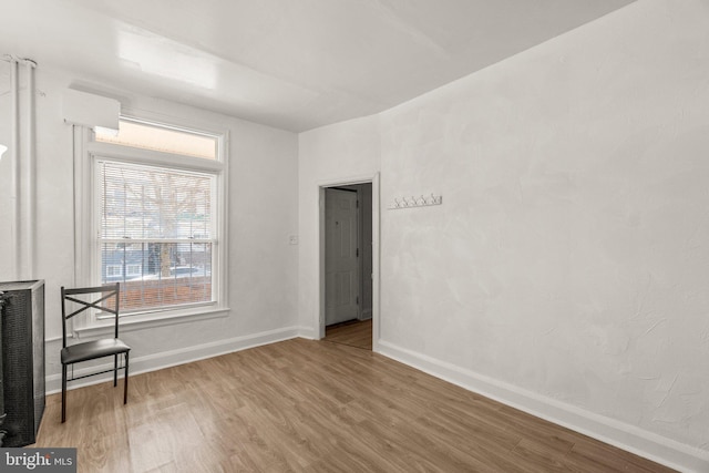 unfurnished room featuring baseboards and wood finished floors