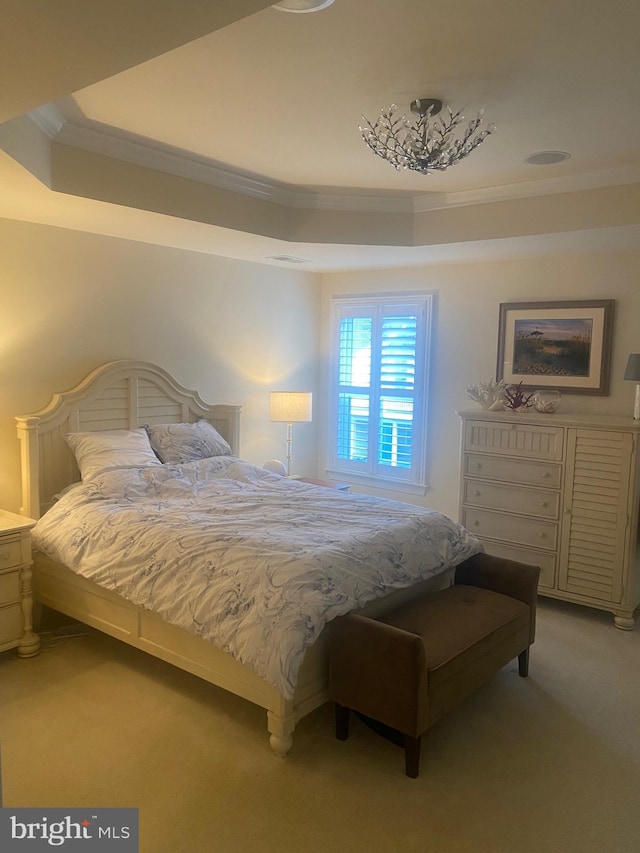 bedroom featuring light carpet, a raised ceiling, and ornamental molding