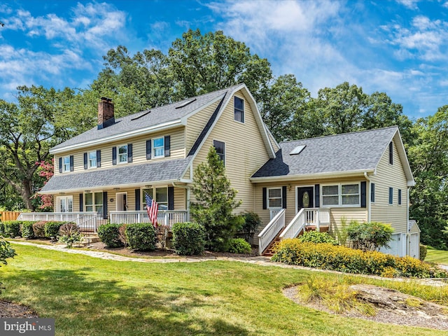 view of front of house featuring a front lawn, a porch, roof with shingles, a chimney, and an attached garage