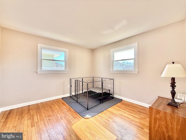 bedroom with baseboards and hardwood / wood-style flooring