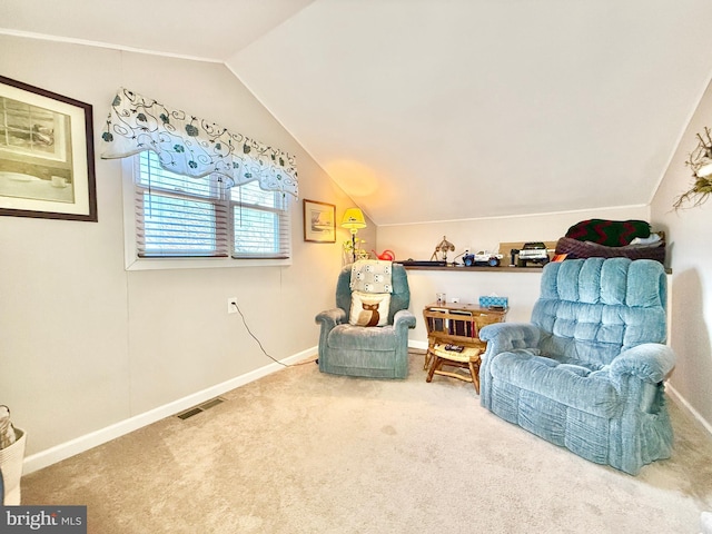 sitting room with visible vents, lofted ceiling, baseboards, and carpet flooring