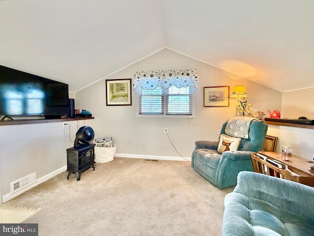 sitting room featuring visible vents, baseboards, lofted ceiling, and carpet