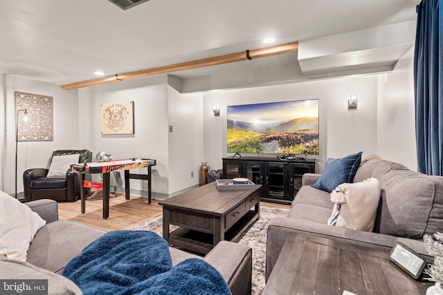 living room featuring recessed lighting, baseboards, and wood finished floors