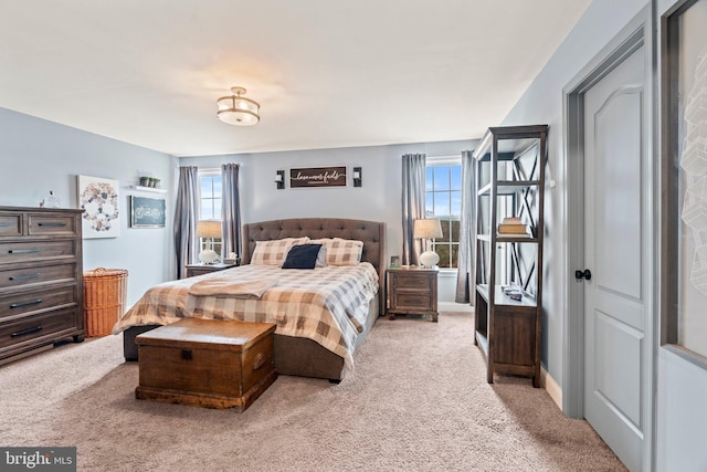 bedroom featuring baseboards and light colored carpet