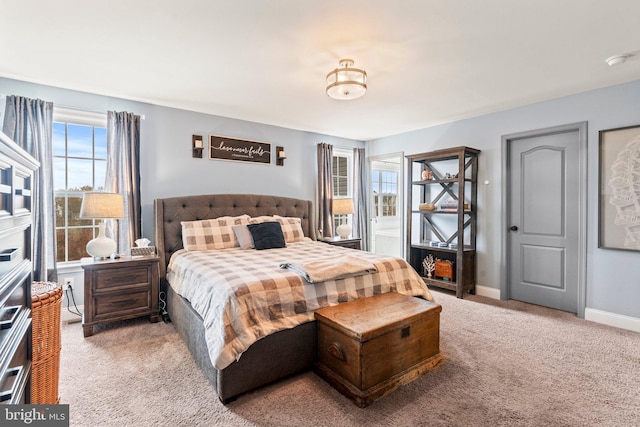 carpeted bedroom featuring baseboards