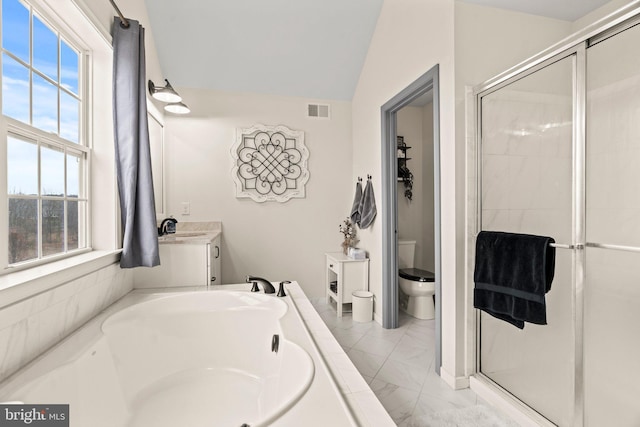 full bath with visible vents, a shower stall, vaulted ceiling, marble finish floor, and vanity