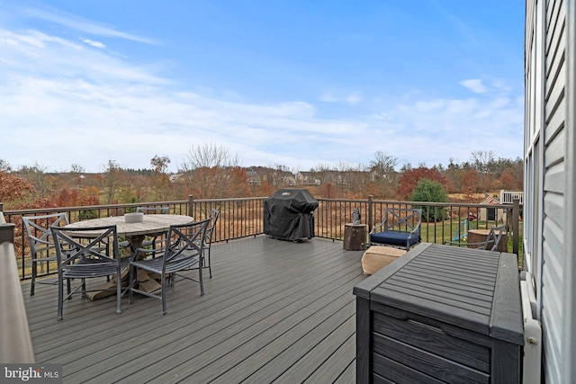 deck with area for grilling and outdoor dining area