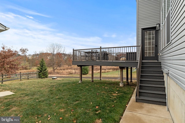 view of yard with stairs, a deck, and fence