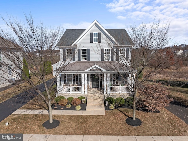 view of front facade featuring a porch and roof with shingles