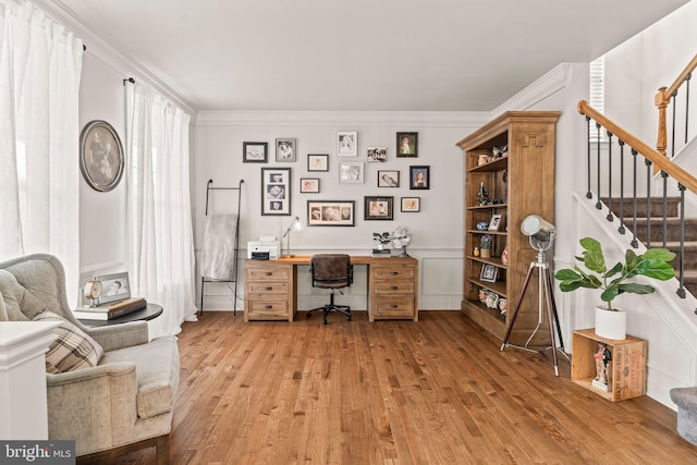 office area with light wood-style floors and ornamental molding