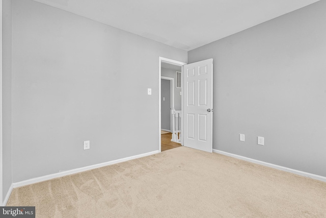 carpeted spare room with baseboards