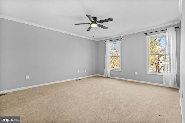 spare room with crown molding, light colored carpet, and baseboards