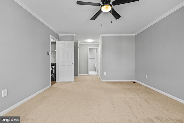 unfurnished bedroom with a spacious closet, crown molding, baseboards, carpet floors, and ensuite bath