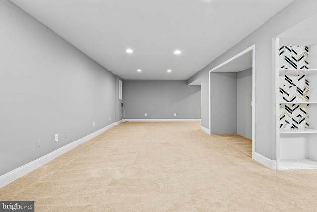 finished below grade area featuring light carpet, recessed lighting, and baseboards