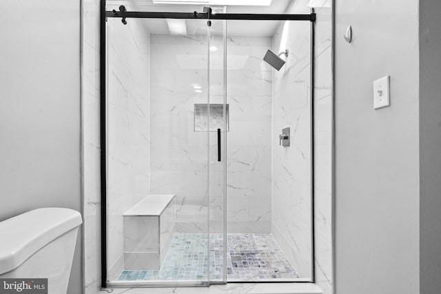 full bath with a marble finish shower and toilet