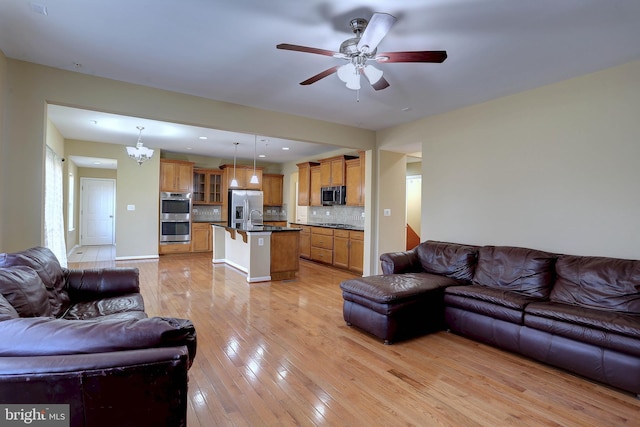 living room with light wood-style flooring, recessed lighting, and a ceiling fan