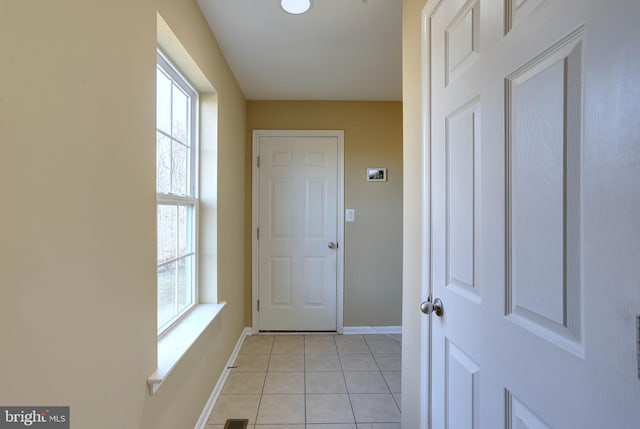 entryway featuring light tile patterned floors and baseboards