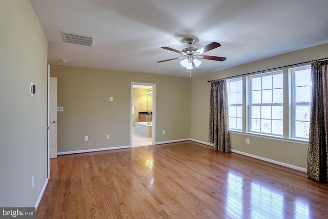 spare room with visible vents, baseboards, and light wood-style floors