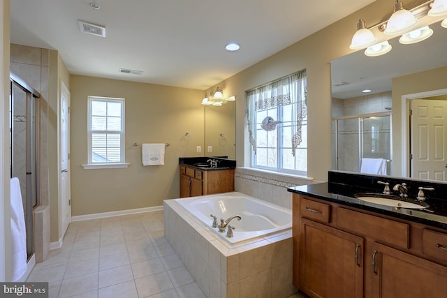 full bath featuring visible vents, a sink, a shower stall, a garden tub, and tile patterned floors