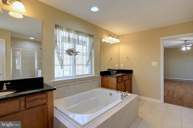 bathroom featuring a sink, a bath, a shower stall, and tile patterned flooring