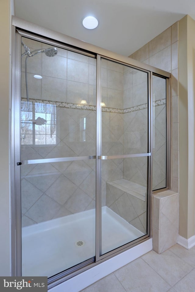 full bath with tile patterned flooring and a shower stall