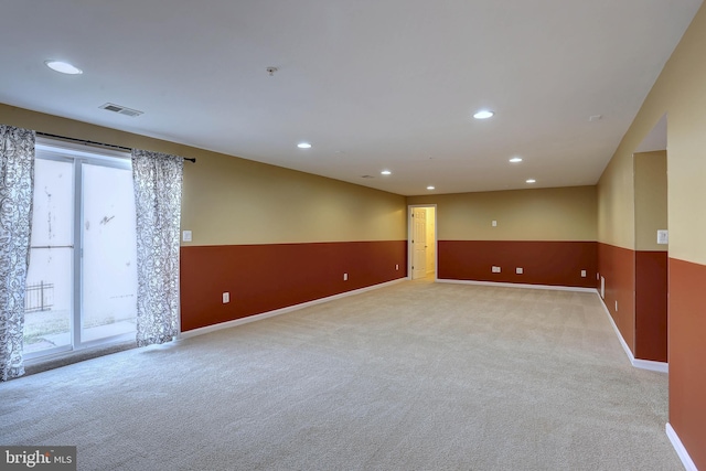 spare room featuring light carpet, visible vents, recessed lighting, and a healthy amount of sunlight